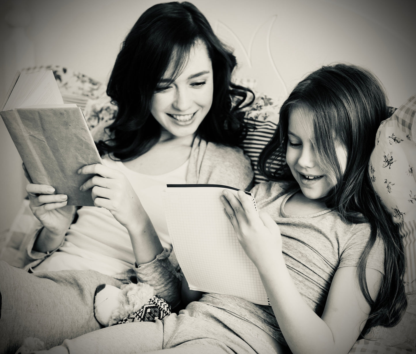 Parent and child sitting together reading and sharing a book, supporting connection and understanding feelings at home